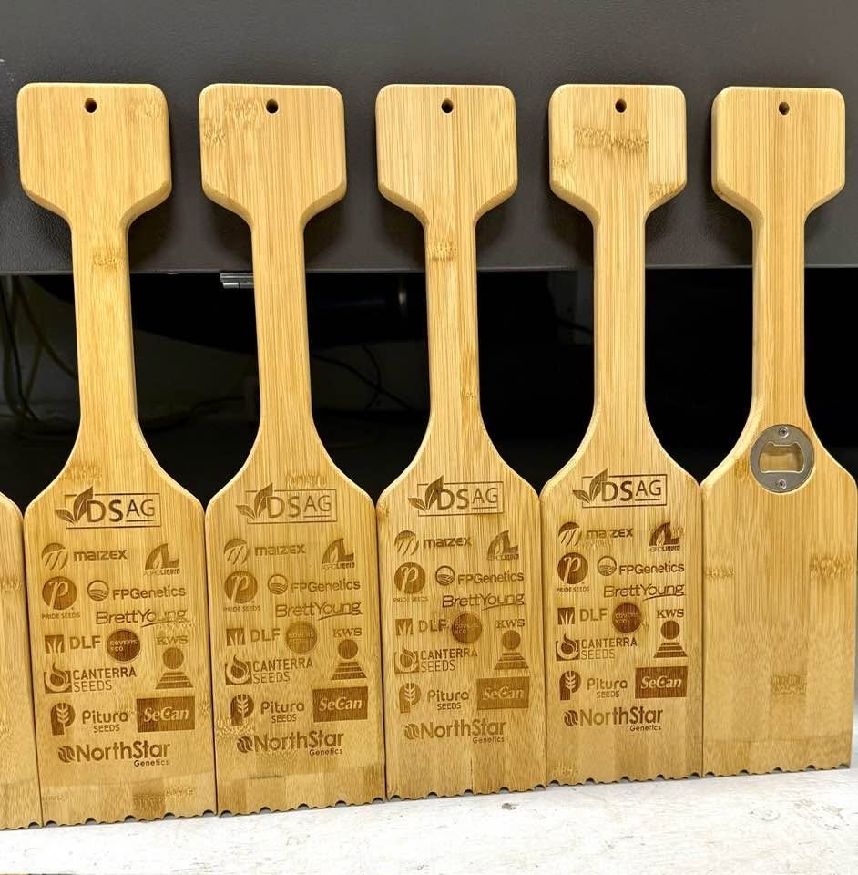 Wooden grill scrapers laser-engraved with multiple sponsor and brand logos